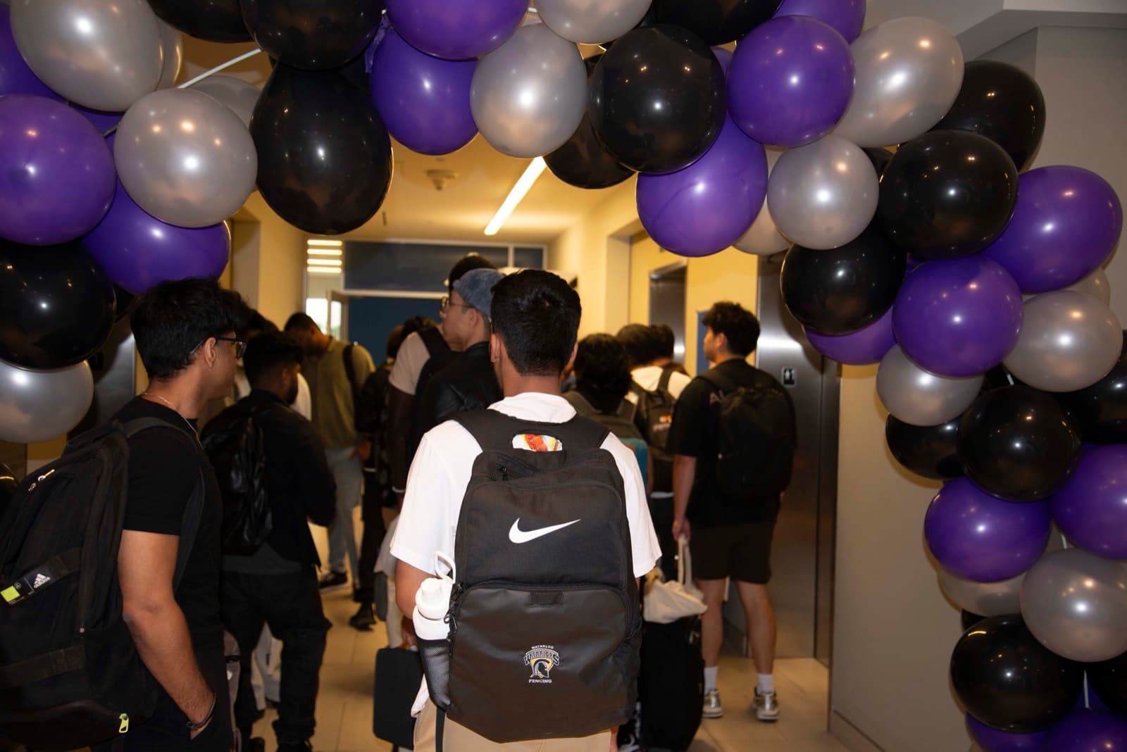 Attendees arriving under balloons at SpurHacks 2025